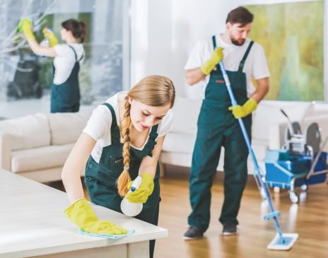 Cleaning service employees with professional equipment cleaning a private home after renovation